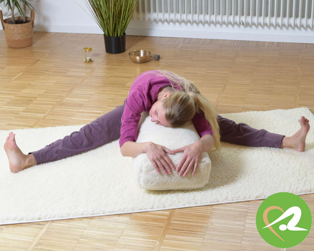 Frau auf Schurwoll-Yogamatte mit Schurwoll-Bolster